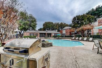 Poolside barbecue grills w/ outdoor kitchen workspace